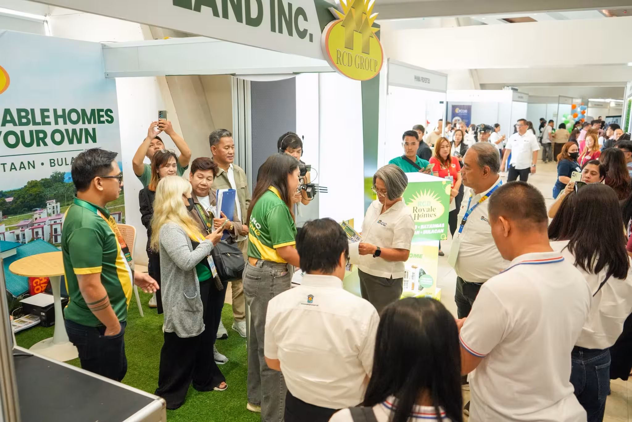 Pag-IBIG Fund Chief Executive Officer Marilyn C. Acosta visits the RCD Land booth during the first day of the Pag-IBIG Housing Fair.